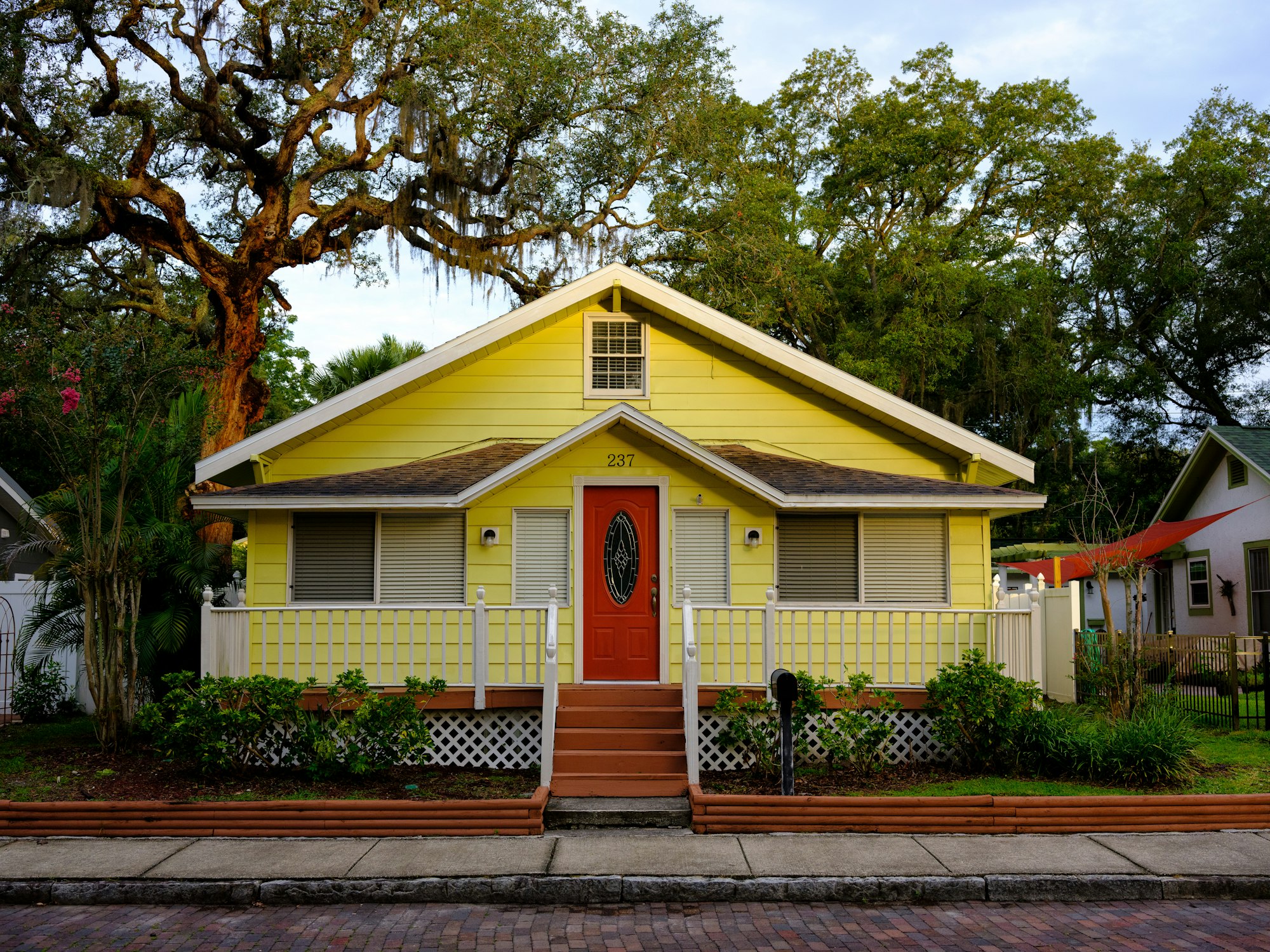 A white and yellow single-story Florida home